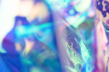 Blurred holographic colorful background. Defocused texture in blue colors.