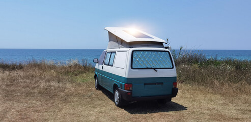 caravan car by the sea in summer beach trees blue sky