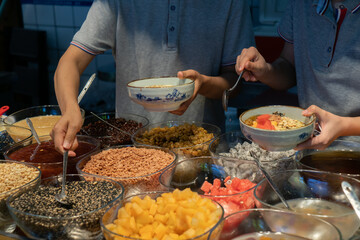 Brown sugar dumplings are a traditional Chinese snack. The cook is adding spices