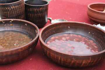 lentils and beans soaked in water in a wooden dish for cooking