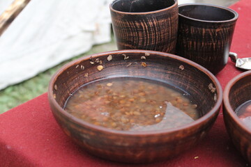 lentils and beans soaked in water in a wooden dish for cooking