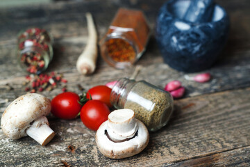 Cooking background with different seasoning. Spices and vegetable, closeup. Rustic style. Food and...