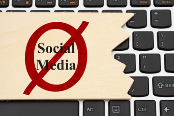 No social media message on a wood sign on a keyboard