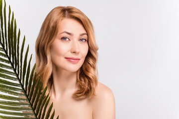 Portrait of attractive woman with leaves flawless clear skin copy space bio cosmetic advert isolated over grey pastel color background