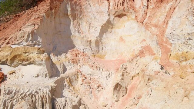 Aerial slowmotion shot of a red canyon or Fairy stream at the border of desert in the Mui Ne village in southern Vietnam