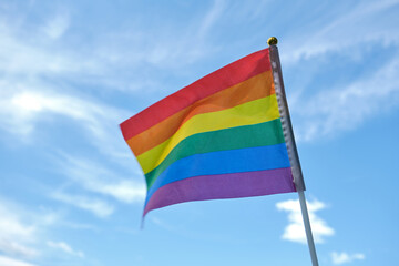 Flag of the LGBT community on sky background