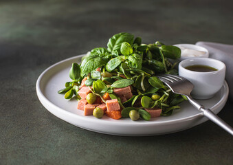 Vegan food, micro greens salad . Microgreens of sunflower, peas, vegetable sausage, carrots, peas, sauce. Summer dish, diet food, healthy eating concept.