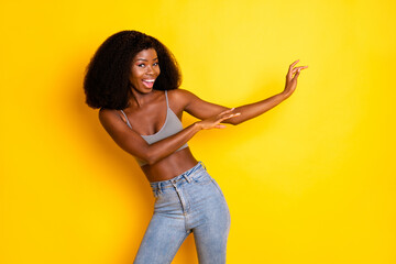 Photo of funky careless lady toothy smile dance have fun wear grey cropped top isolated yellow...