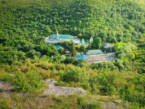 High angle view from altitude to the Saharna Monastery, Moldova. Idyllic place with the church in the middle of woods on the gorge valley
