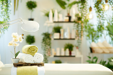 towels and massage table in modern beauty studio