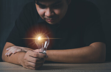business man hand holding light bulb, new idea concept with innovation and inspiration, innovative technology in science and communication concept.
