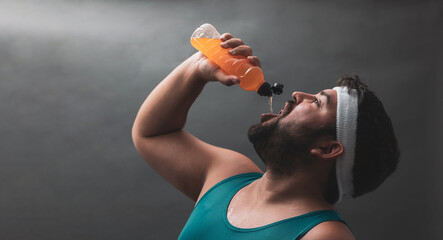 
a portrait of a fat boy drinking a drink.
healthy sport.
copyspace.
