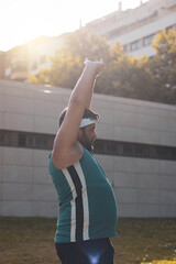 a fat boy stretching his arms after doing sports.
willpower.