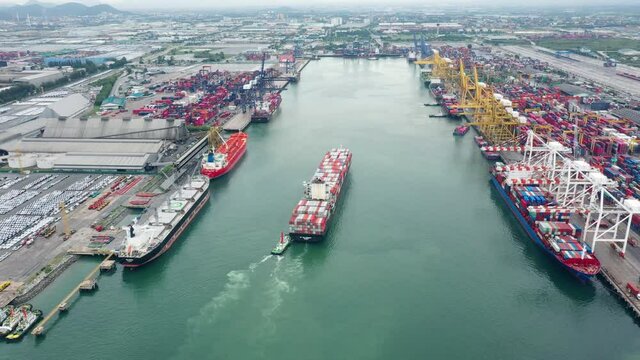 Aerial view of cargo ship carrying container and running 
near international custom sea port for export cargo.