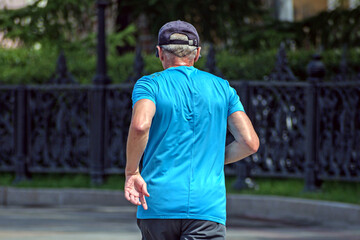 A man runs along the city embankment