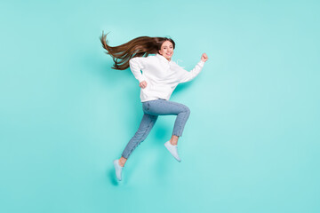 Fototapeta na wymiar Full length body size view of lovely cheerful successful girl jumping running isolated over bright teal turquoise color background