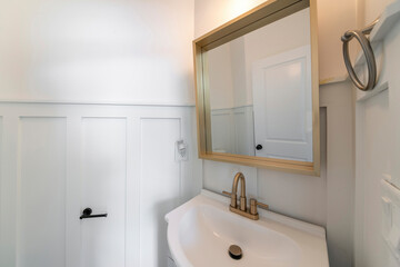 Interior of a powder room with a view of sink and mirror