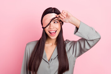 Portrait of attractive cheerful girl touching blindfold waking up peeking having fun party isolated...