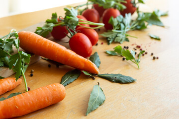 Assortment of raw vegetables on wooden table.
