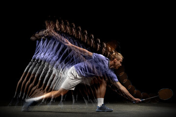 Young male badminton player, shuttler in motion and action on dark background. Stroboscope effect.