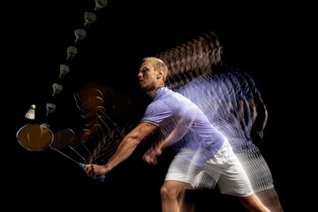 Young male badminton player, shuttler in motion and action on dark background. Stroboscope effect.
