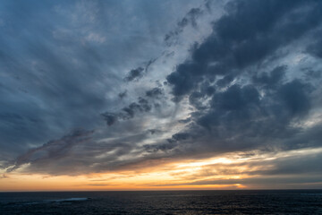 Naklejka na ściany i meble early morning sunrise over sea. ocean sunset on sea water with sunset sky. seascape sundown.