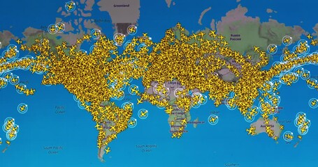 Time lapse of busy air traffic over map on digital screen.
