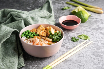 asian rice noodle soup with fried tofu and shrimps