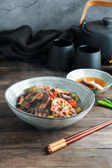 Lotus root or Rhizome stir-fry with Shiitake mushrooms, spices, hot peppers, dark soy sauce and green onions
