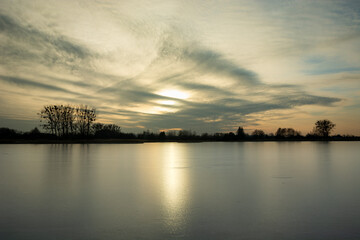 Fototapeta na wymiar A frozen lake and sunshine on the ice sheet
