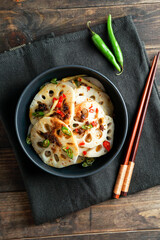 spicy lotus root salad on the white stone background, asian food 
