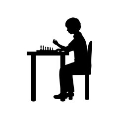 Silhouette boy playing chess seated at table. Symbol sport.