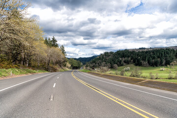 Fototapeta na wymiar oregon empty road. summer route. travel way with landscape. highway road among forest. roadway