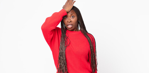 afro black adult woman raising palm to forehead thinking oops, after making a stupid mistake or...