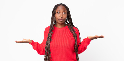 afro black adult woman feeling puzzled and confused, unsure about the correct answer or decision,...