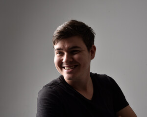 Obraz premium Close up head and shoulders portrait of a brunette. young man with a variety of expressive facial expressions. Isolated on a light grey studio background.