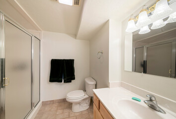 Bathroom with vanity sink, shower stall and tile floor