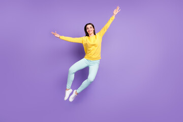 Fototapeta na wymiar Full size photo of cheerful young happy woman jump up good mood smile isolated on purple violet color background
