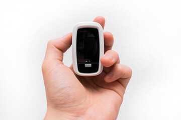 Man's hand holds medical modern pulse device oximeter close-up on white background