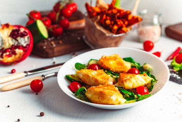 Camembert. Fried camembert cheese with batat fries. Cheese with salad with tomatoes. Fresh food
