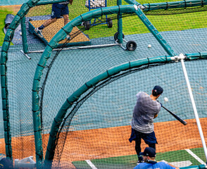 Baseball player taking batting practice before the game