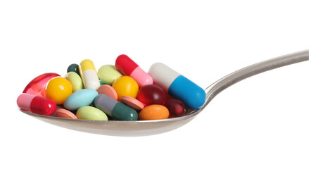 Different colorful pills in spoon isolated on white