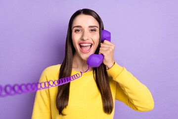 Fototapeta premium Photo of cheerful young happy pretty woman hold hands telephone talk smile isolated on purple color background