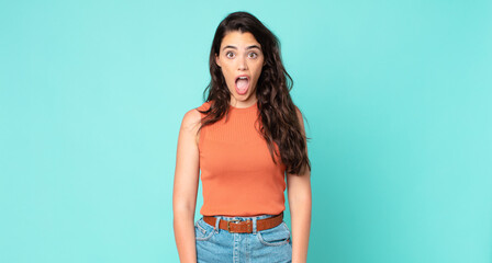 young pretty woman feeling terrified and shocked, with mouth wide open in surprise