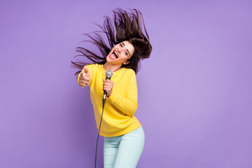 Photo of cheerful young positive woman point finger you fly hair mic singer karaoke isolated on...