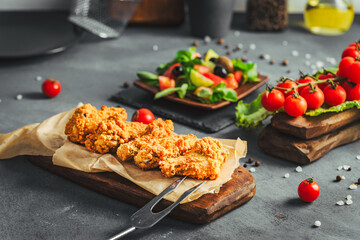 Chicken wings. Chicken wings with salad on wooden stand.