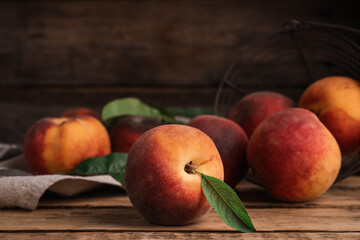 Fresh ripe juicy peaches on wooden table
