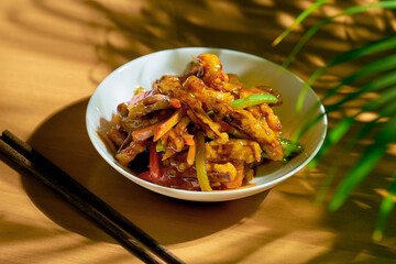 Fried eggplants in sweet and sour sauce with peppers and tomatoes. Chinese recipe and cuisine