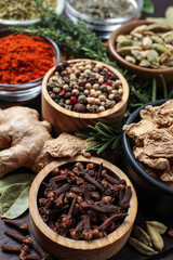 Different natural spices and herbs on table, closeup