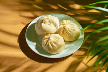 Baozi with different fillings (beef or pork) in a white plate. Chinese recipe and cuisine. Chinese...